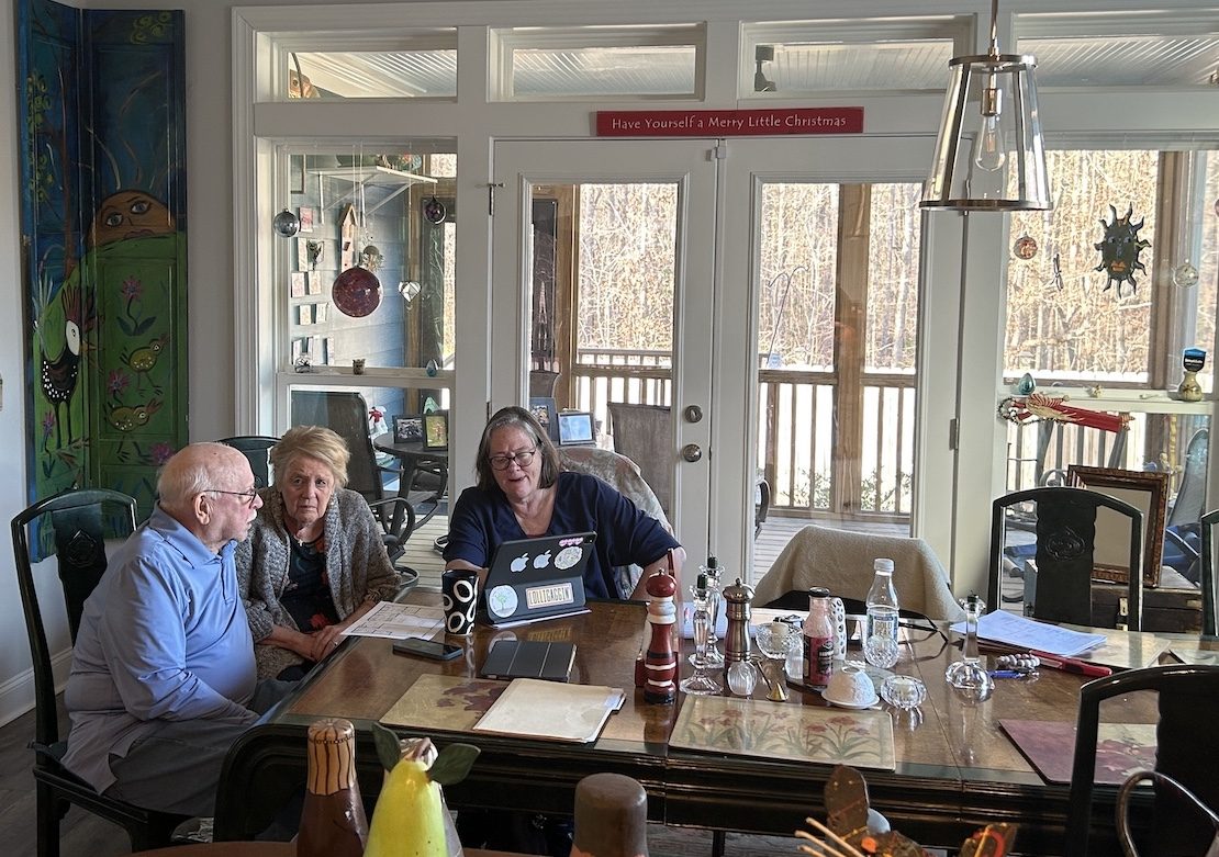 Jennie assisting clients at the dining room table