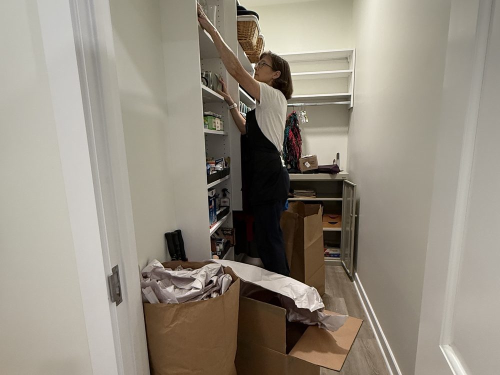 A Here to Home team member organizing a client’s pantry
